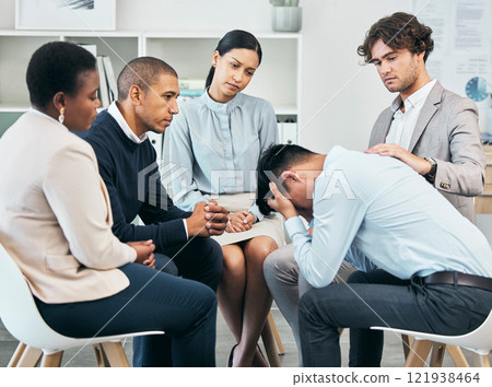 Depression, support and unity by colleagues comforting male after getting bad news at work. Community care from workers sitting together, supporting their friend after being fired or through grief Depression, support and unity by colleagues comforting male after getting bad news at work. Community care from workers sitting together, supporting their friend after being fired or through grief 121938464