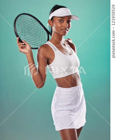 Tennis player, sports uniform and racket in the hands of a beautiful woman looking happy and ready to play with a positive attitude. Confident, fit and athletic female against a studio background Tennis player, sports uniform and racket in the hands of a beautiful woman looking happy and ready to play with a positive attitude. Confident, fit and athletic female against a studio background 121938529