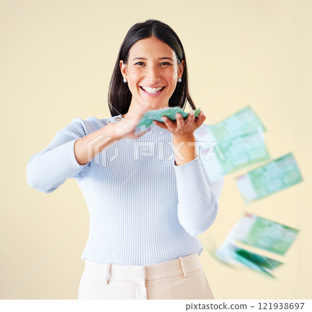Wealthy, rich and happy woman throwing money smiling about her financial success and freedom. Portrait of an excited young female having fun and enjoying her cash and ready to spend 121938697