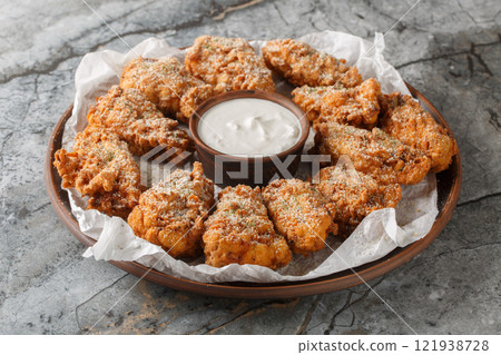 Tasty Bburinkle fried chicken coated with cheese powder, one of popular food in Korea closeup on the plate. Horizontal Tasty Bburinkle fried chicken coated with cheese powder, one of popular food in Korea closeup on the plate. Horizontal 121938728