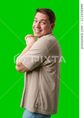 A cheerful man with a friendly smile poses against a bright green background A cheerful man with a friendly smile poses against a bright green background 121938946
