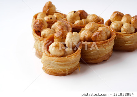 Delicious traditional dessert filled with nuts showcased on a white background 121938994