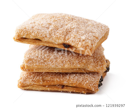 Flaky pastries dusted with sugar stacked neatly on a clean surface 121939297