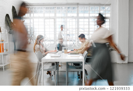 Blurred designers, marketing or freelance professionals working together in a modern office. Business men and women busy, walking and active in a creative workplace, workstation or environment Blurred designers, marketing or freelance professionals working together in a modern office. Business men and women busy, walking and active in a creative workplace, workstation or environment 121939333