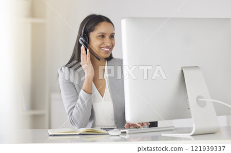 Call center agent talking or consulting online clients with a headset and working on a desktop computer in a company office. black woman customer support worker helping people with questions Call center agent talking or consulting online clients with a headset and working on a desktop computer in a company office. black woman customer support worker helping people with questions 121939337