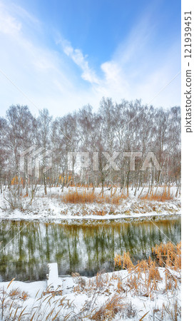 Brilliant landscape in city park with snowy trees and beautiful frozen river. 121939451