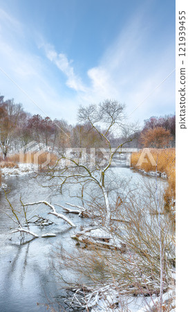 Outstanding landscape in city park with snowy trees and beautiful frozen river. Outstanding landscape in city park with snowy trees and beautiful frozen river. 121939455