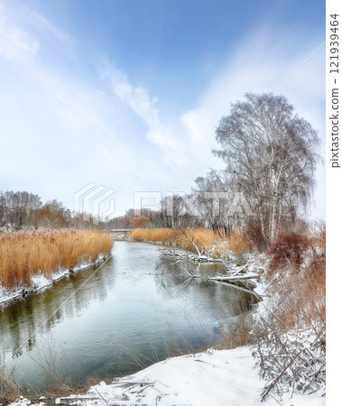 Brilliant landscape in city park with snowy trees and beautiful frozen river. Brilliant landscape in city park with snowy trees and beautiful frozen river. 121939464