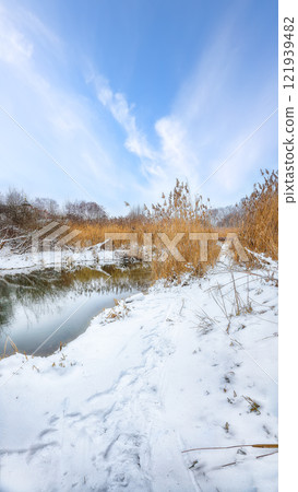 Outstanding landscape in city park with snowy trees and beautiful frozen river. Outstanding landscape in city park with snowy trees and beautiful frozen river. 121939482