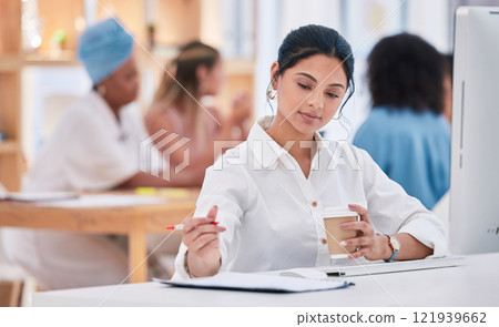 Business intern writing notes, planning ideas and brainstorming while working on strategy in a startup agency. Organized young woman drinking coffee, developing goals and thinking of innovation 121939662