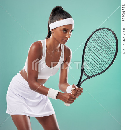 Tennis player, sporty and fit athlete ready to play in training, workout and exercise or match, game or competition. Sporty, active or healthy woman with racket looking motivated on studio background 121939758