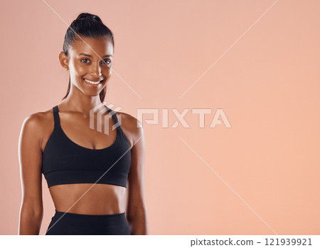 Fitness, happy and healthy female athlete with a smile for wellness and body care with copy space background. Portrait fit sport model smiling and slim after training, exercise or workout rotuine Fitness, happy and healthy female athlete with a smile for wellness and body care with copy space background. Portrait fit sport model smiling and slim after training, exercise or workout rotuine 121939921