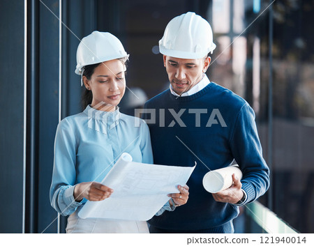 Architecture, civil and architect engineers busy with a floor plan or blueprint strategy on paper inside a office building. Designers working, planning and analyzing a construction project together Architecture, civil and architect engineers busy with a floor plan or blueprint strategy on paper inside a office building. Designers working, planning and analyzing a construction project together 121940014