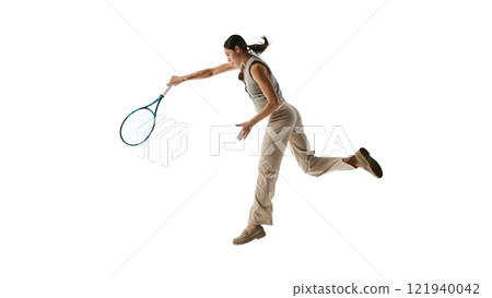 Woman executing dynamic swing with tennis racket, representing mastery and commitment to achieving career excellence against white studio background. Woman executing dynamic swing with tennis racket, representing mastery and commitment to achieving career excellence against white studio background. 121940042
