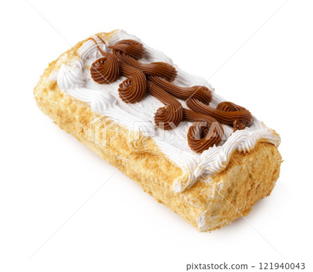 Delicious dessert with layers of cake, cream, and chocolate frosting topped with decorative swirls 121940043