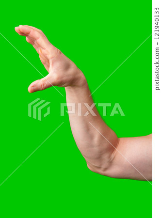 Hand raised against a vibrant green background 121940133