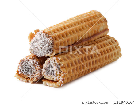 Delicious rolled wafers filled with chocolate cream and coated in coconut flakes displayed on a clean background Delicious rolled wafers filled with chocolate cream and coated in coconut flakes displayed on a clean background 121940164