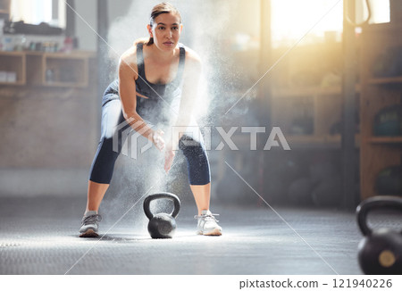 Fitness kettlebell and gym woman with chalk on hands during weightlifting workout, exercise or training. Athletic, active and strong girl exercising with weight equipment to build muscle strength Fitness kettlebell and gym woman with chalk on hands during weightlifting workout, exercise or training. Athletic, active and strong girl exercising with weight equipment to build muscle strength 121940226