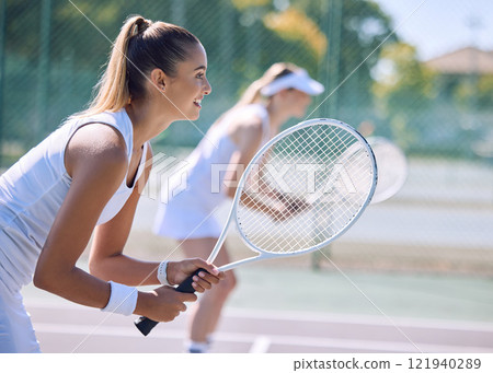 Female tennis player or sports woman with racket and sports gear playing a match outdoors sport court. Fit young girl enjoying hobby, exercising or competitive activity with equipment or sporty gear 121940289