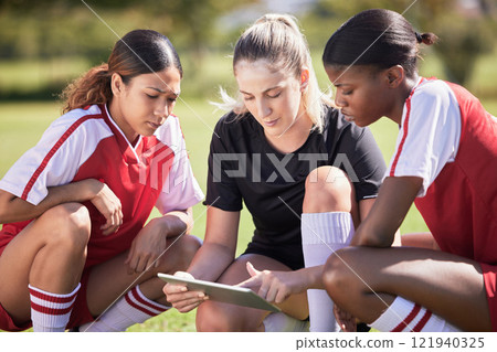 Football girls with a digital tablet checking fitness goal progress or online score on exercise app during practice on field. Sports or soccer player and coach looking at date or schedule on software 121940325