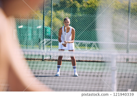 Female tennis player with racket equipment or gear preparing for match at outdoor sport activity from opponent POV. Young athletic or sportswoman standing ready and looking competitive in sportswear Female tennis player with racket equipment or gear preparing for match at outdoor sport activity from opponent POV. Young athletic or sportswoman standing ready and looking competitive in sportswear 121940339