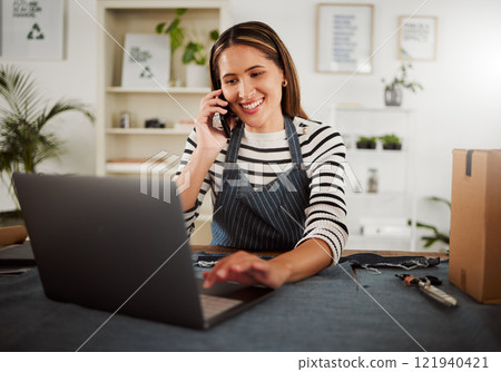 Multitasking, phone call and laptop for designer in a fashion boutique, workshop or studio talking, discussing and sharing design. Tailor or seamstress browsing trendy, stylish and fashionable ideas 121940421
