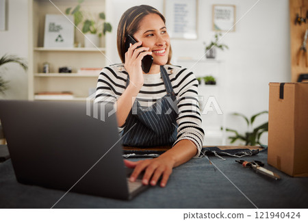 Female fashion entrepreneur on a phone call taking online packaging order for new tailor design or dress. Happy small business owner seamstress with dispatch box, making sales talking on a cellphone Female fashion entrepreneur on a phone call taking online packaging order for new tailor design or dress. Happy small business owner seamstress with dispatch box, making sales talking on a cellphone 121940424