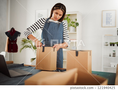 Creative designer packing order in box, tailor organizing package for courier delivery service and closing product parcel working at design studio, boutique or shop. Business owner unpacking supplies Creative designer packing order in box, tailor organizing package for courier delivery service and closing product parcel working at design studio, boutique or shop. Business owner unpacking supplies 121940425
