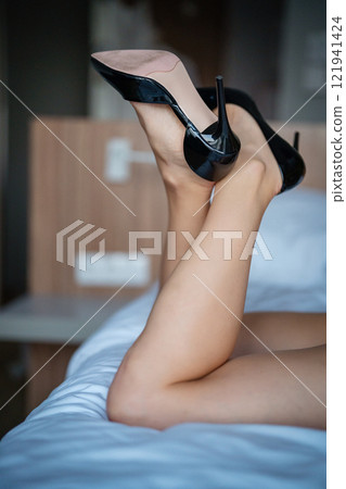 Woman feet high heels shoes in hotel, closeup 121941424