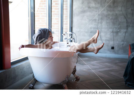 Woman feet in bathrobe at home, closeup 121941632