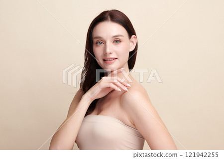 Beautiful young woman with clean fresh skin on beige background, Face care, Facial treatment, Cosmetology, beauty and spa, women portrait. 121942255