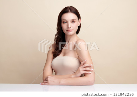 Beautiful young woman with clean fresh skin on beige background, Face care, Facial treatment, Cosmetology, beauty and spa, women portrait. 121942256