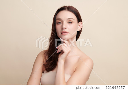 Beautiful young woman with clean fresh skin on beige background, Face care, Facial treatment, Cosmetology, beauty and spa, women portrait. 121942257