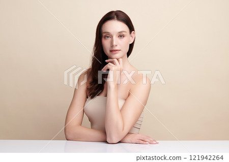 Beautiful young woman with clean fresh skin on beige background, Face care, Facial treatment, Cosmetology, beauty and spa, women portrait. Beautiful young woman with clean fresh skin on beige background, Face care, Facial treatment, Cosmetology, beauty and spa, women portrait. 121942264
