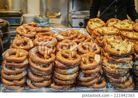 Freshly baked pretzels on display at market stall. Concept of traditional bakery and street food Freshly baked pretzels on display at market stall. Concept of traditional bakery and street food 121942383