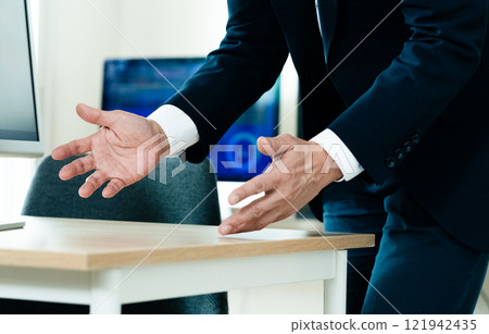 A businessman explaining in front of a computer 121942435