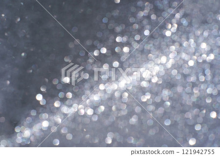 Abstract silver bokeh light pattern with circular glittering effect on dark Abstract silver bokeh light pattern with circular glittering effect on dark 121942755