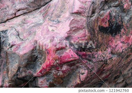 Rhodonite stone, unpolished specimen of colorful mineral Rhodonite stone, unpolished specimen of colorful mineral 121942760