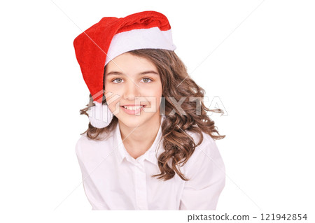 Caucasian female teen smiling in santa hat with curly brown hair and white shirt Caucasian female teen smiling in santa hat with curly brown hair and white shirt 121942854