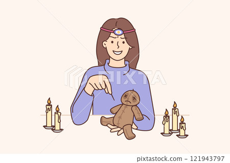 Voodoo doll in hands woman magician who uses black magic to cast spells on person Voodoo doll in hands woman magician who uses black magic to cast spells on person 121943797
