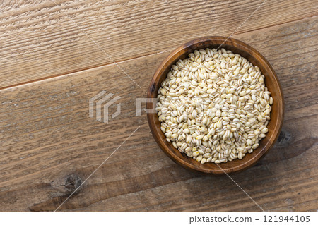 Background of glutinous barley served on a plate on a wooden table 121944105