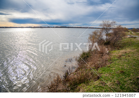 Landscape view of Salina nature park with flamingos near Ulcinj town in winter time in Montenegro Landscape view of Salina nature park with flamingos near Ulcinj town in winter time in Montenegro 121945807