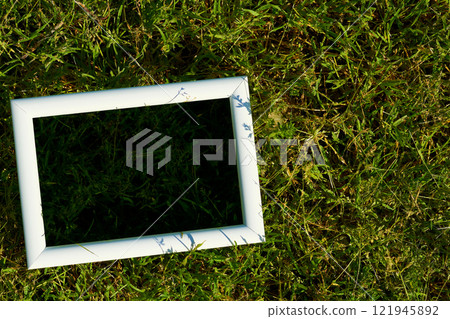 White frame with black space for text on freshly greenery grass White frame with black space for text on freshly greenery grass 121945892
