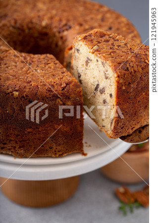 Pecan caramel pound cake baked in a bundt pan served on a cake stand 121945963