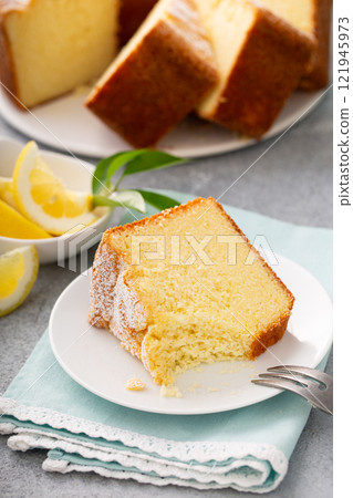 Lemon pound cake baked in a bundt pan topped with powdered sugar 121945973