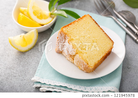 Lemon pound cake baked in a bundt pan topped with powdered sugar Lemon pound cake baked in a bundt pan topped with powdered sugar 121945978