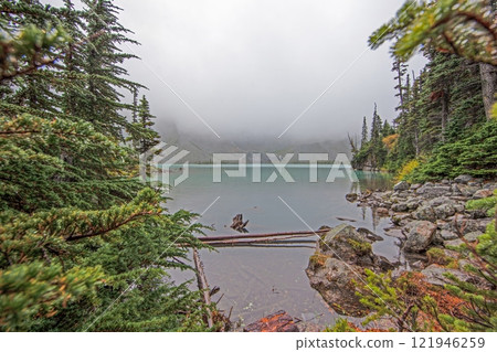 Hiking view near Mt Garibaldi with turquoise lake and dramatic clouds in the mountains 121946259