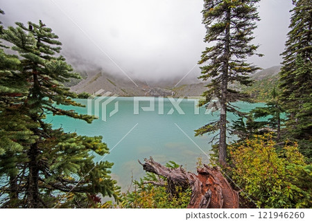 Hiking view near Mt Garibaldi with turquoise lake and dramatic clouds in the mountains Hiking view near Mt Garibaldi with turquoise lake and dramatic clouds in the mountains 121946260