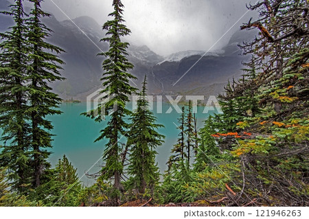 Hiking view near Mt Garibaldi with turquoise lake and dramatic clouds in the mountains 121946263