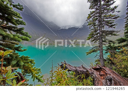 Hiking view near Mt Garibaldi with turquoise lake and dramatic clouds in the mountains 121946265